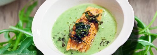Ruccola cream soup with chunk salmon and hazelnut oil