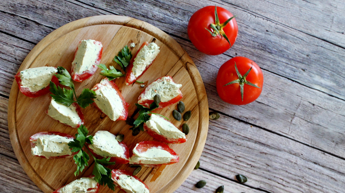 Tomato boats stuffed with green herbs and cottage cheese